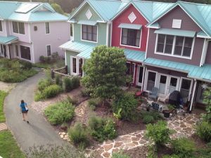 Bird's eye view of Pacifica's colorful homes, abundant greenery, and walking paths